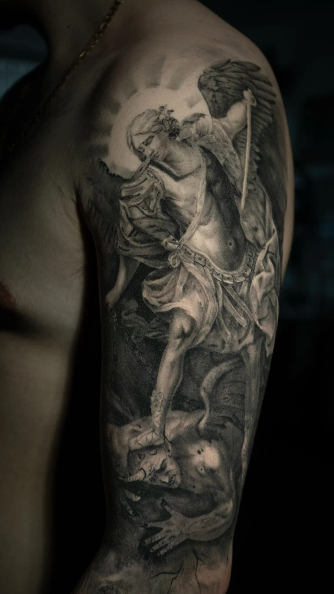 Archangel Michael defeating demon black and gray arm tattoo in Tacoma by RCD Ink