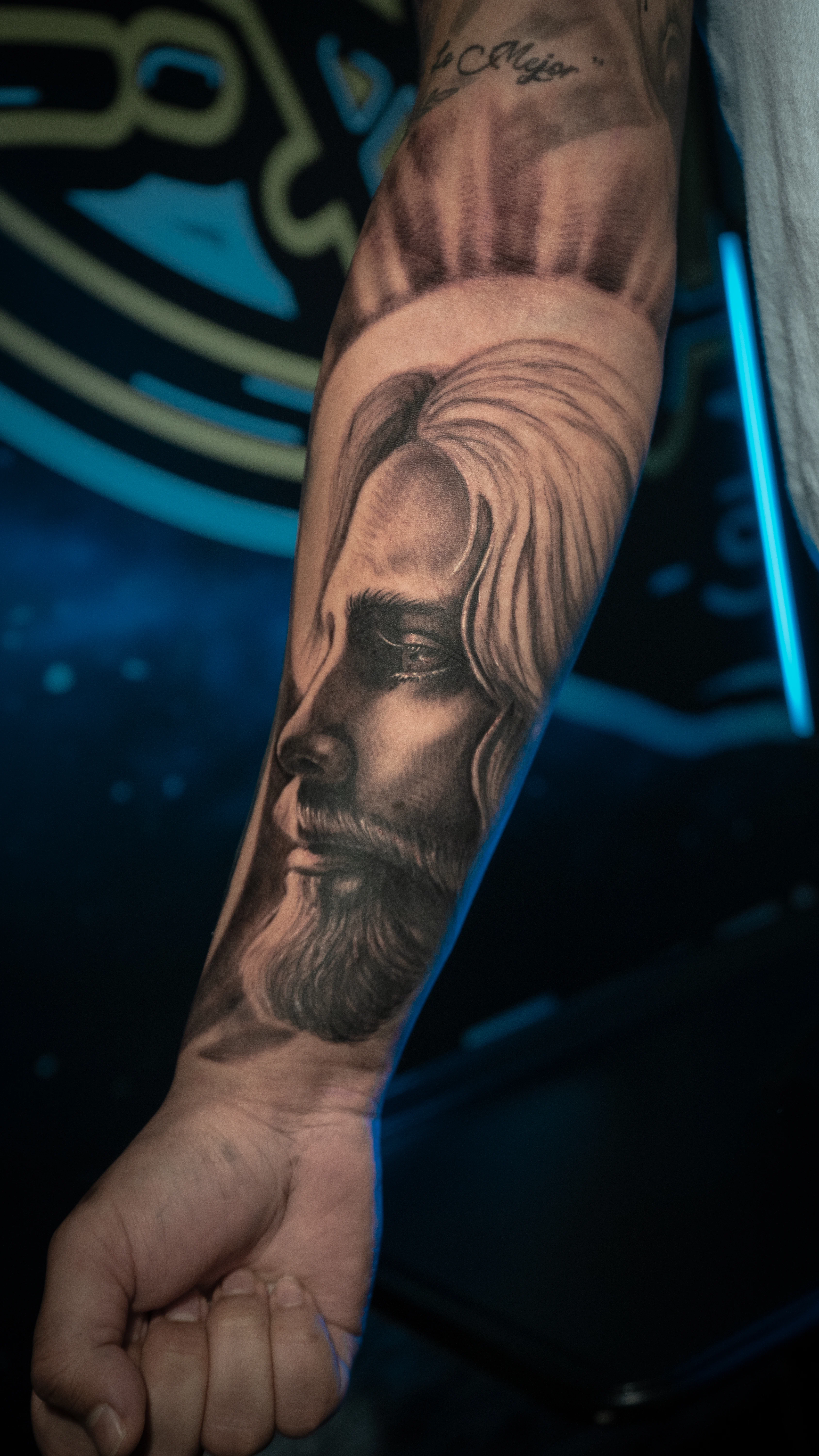 Jesus profile forearm tattoo in black and gray realism by RCD Ink Tacoma