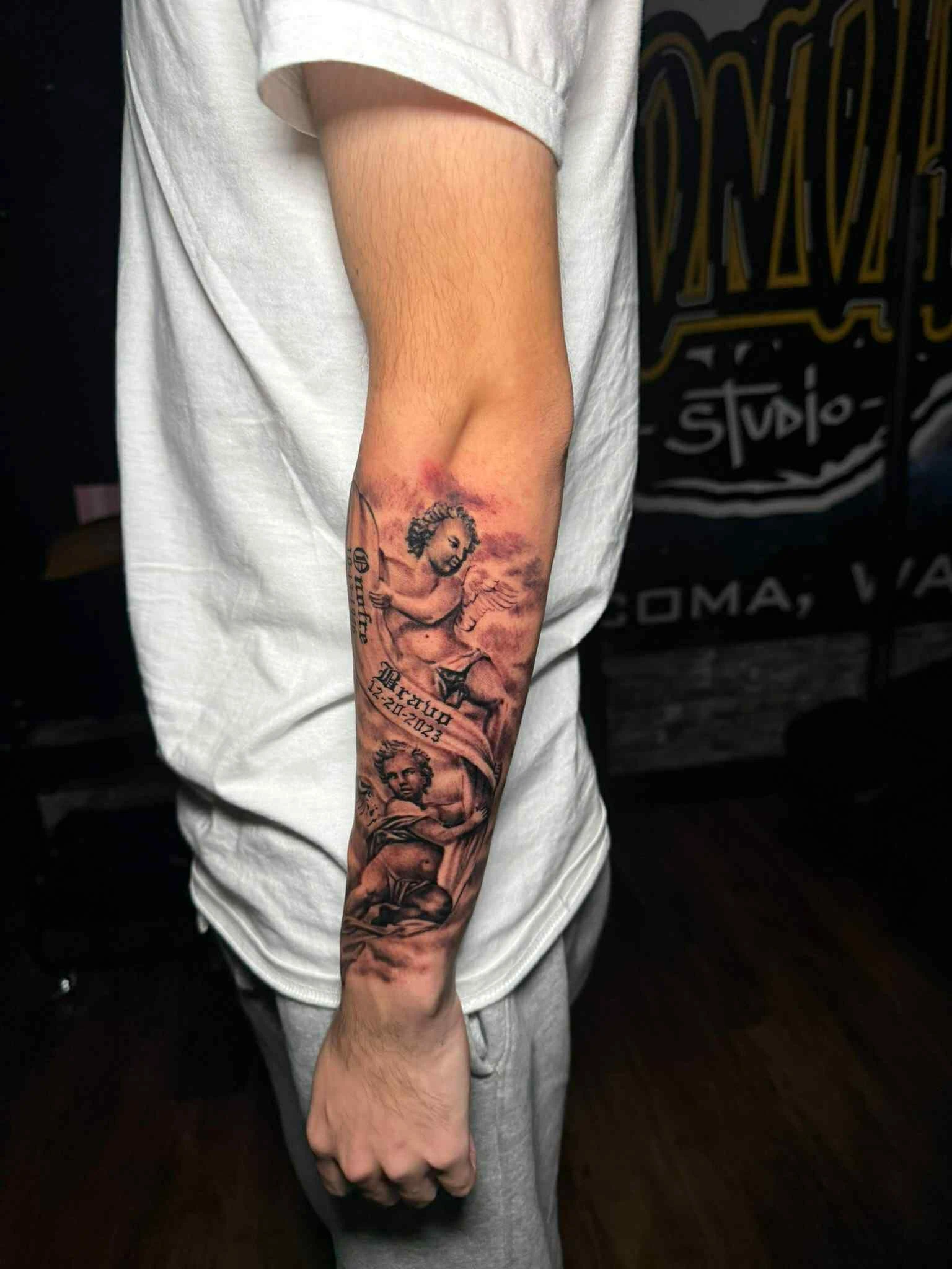 Religious cherubs memorial forearm tattoo in Tacoma by RCD Ink