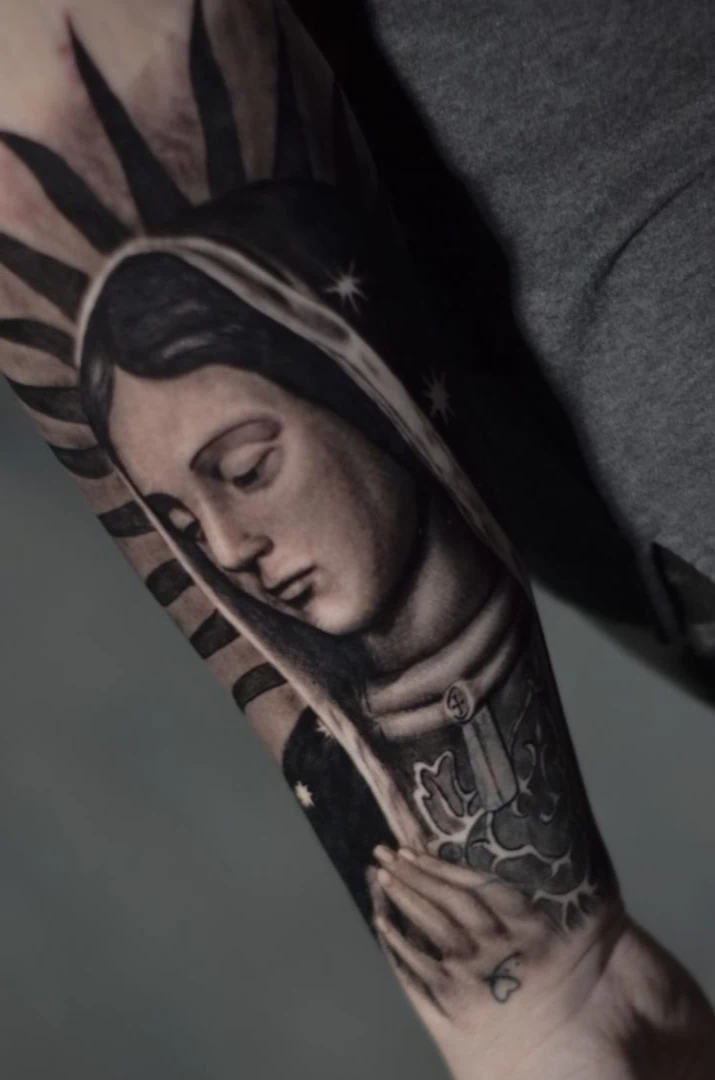 Virgin Mary portrait forearm tattoo in Tacoma — black and gray realism by RCD Ink
